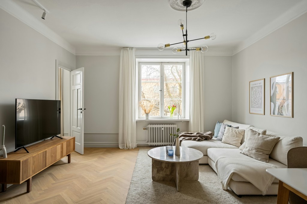 Połączenie ciepłego drewna i szarości w przytulnym skandynawskim wnętrzu